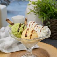 I05.Triple Ice Cream Delight: Green Tea, Vanilla, Mango with Chocolate Syrup · Scoop of Green tea, vanilla, and mango ice cream