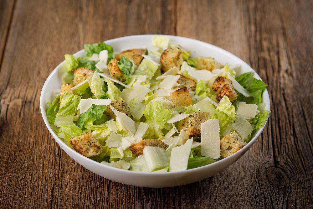 Caesar Salad · Crisp romaine lettuce hearts, toasted garlic croutons and shaved Asiago cheese.