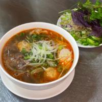 22. Bun Bo Hue  · Spicy beef noodle soup. Served spicy. Round shanghai rice noodle, beef shank, slice Vietname...
