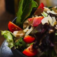 Capricciosa Salad · Mixed greens, hearts of palm, tomatoes, Italian dressing and Parmesan shavings.