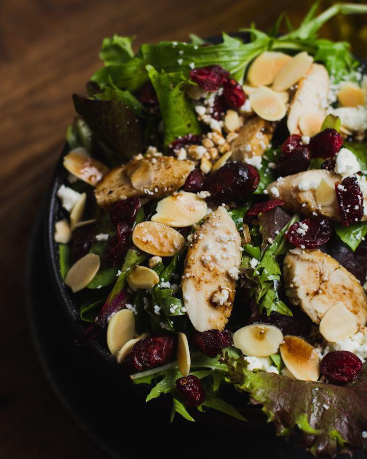 Tutto Salad · Mixed greens, chicken, cranberries, almonds and feta cheese with passion fruit dressing.