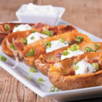 Potato Skins · Topped with cheddar-jack cheese, bacon, green onions and seasoned sour cream 
