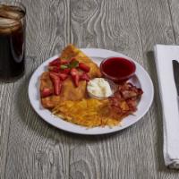 Strawberry Crepes Combo · Luscious strawberries and cream crepes, crowned with whipped cream. Served with hash browns ...