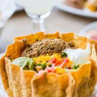 Taco Salad · Hearts of romaine and iceberg lettuce, tomatoes, ground beef, and cheddar cheese tossed with...