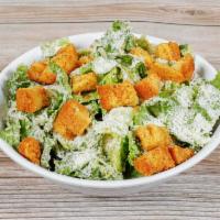 Caesar Salad · Chopped romaine lettuce, shaved Parmesan and homemade croutons with Caesar dressing.