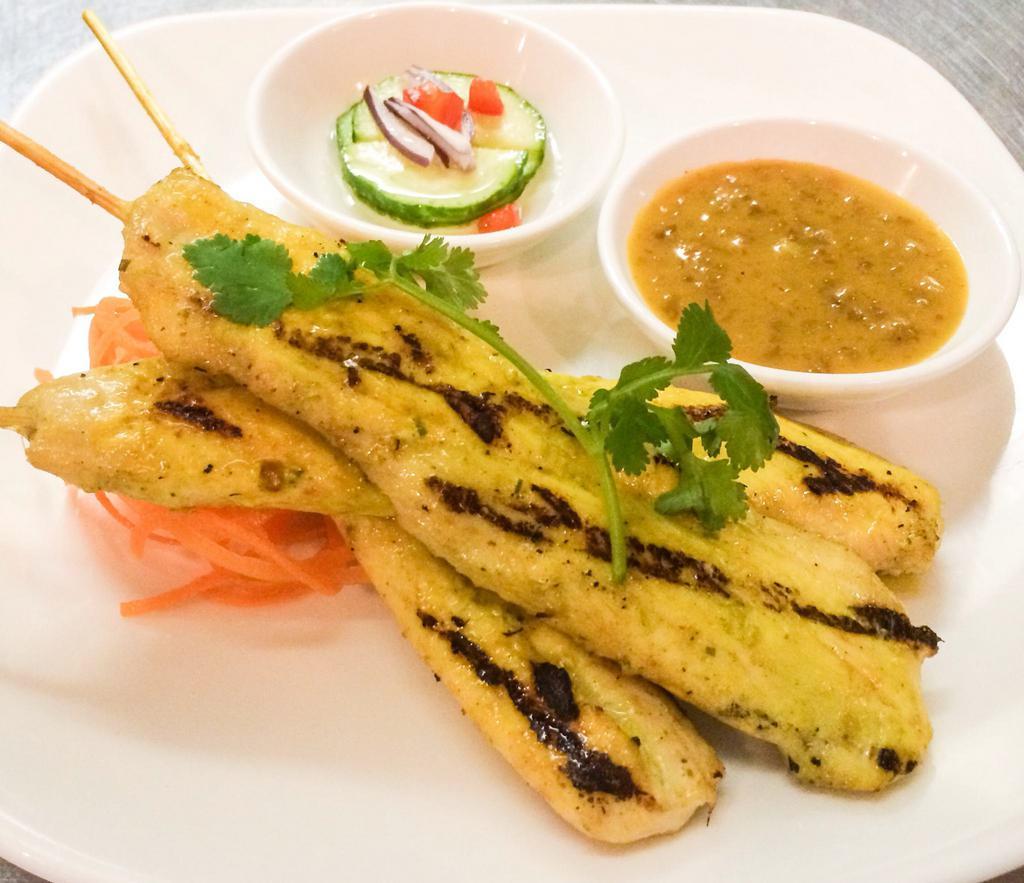 Chicken Sate  · Grilled marinated chicken on a skewer served with peanut sauce and cucumber salad.