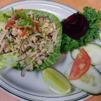 Labb Gai Salad · Chicken salad. Chopped chicken with lime juice, onion, toasted rice, mint leaves served with...