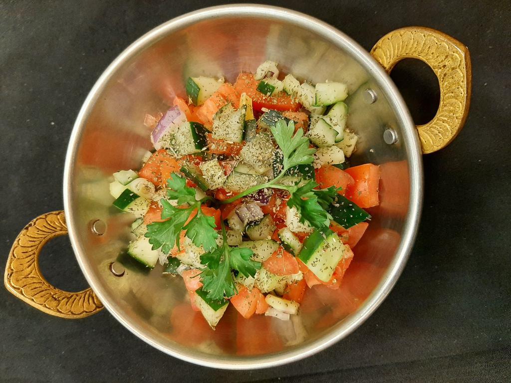 Shirazi Salad · Chopped cucumber, tomato, onion, mint with lemon juice, and olive oil dressing.