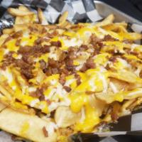 Loaded Fries · Flat fries topped with melted cheddar jack & bacon. Served with a side of buttermilk ranch d...
