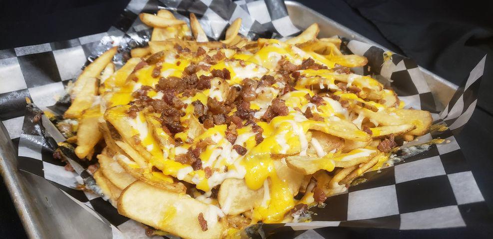 Loaded Fries · Flat fries topped with melted cheddar jack & bacon. Served with a side of buttermilk ranch dressing.  