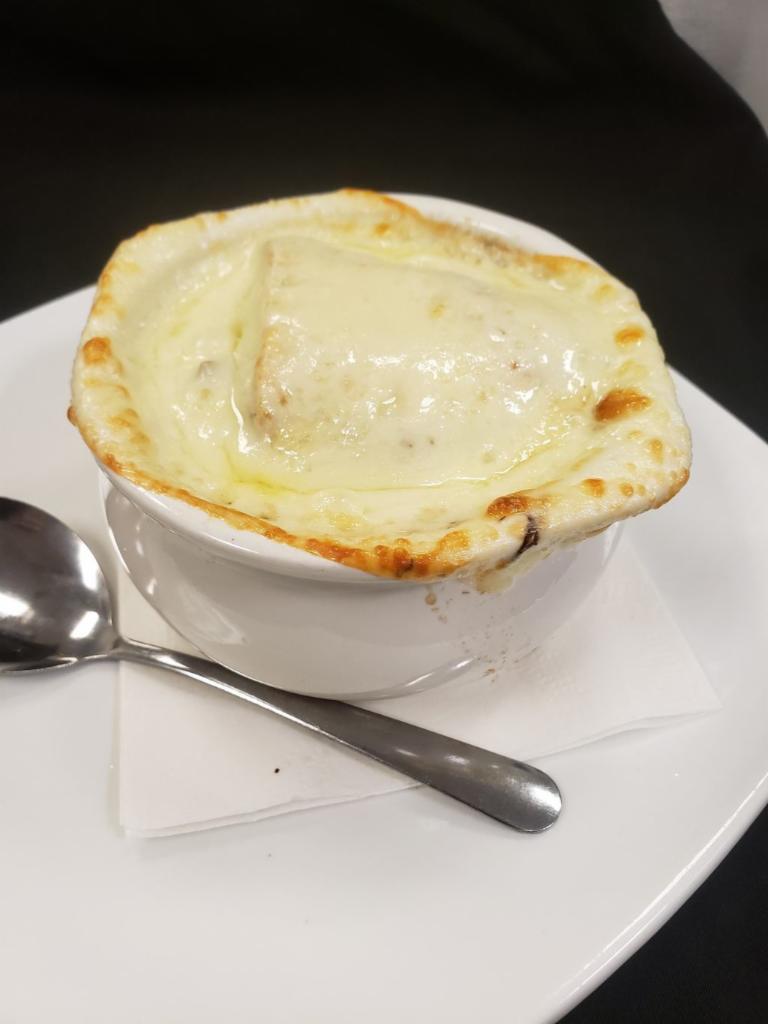 French Onion · Red & yellow onions slowly simmered in a seasoned broth, and topped with a giant French bread crouton and melted provolone cheese. 