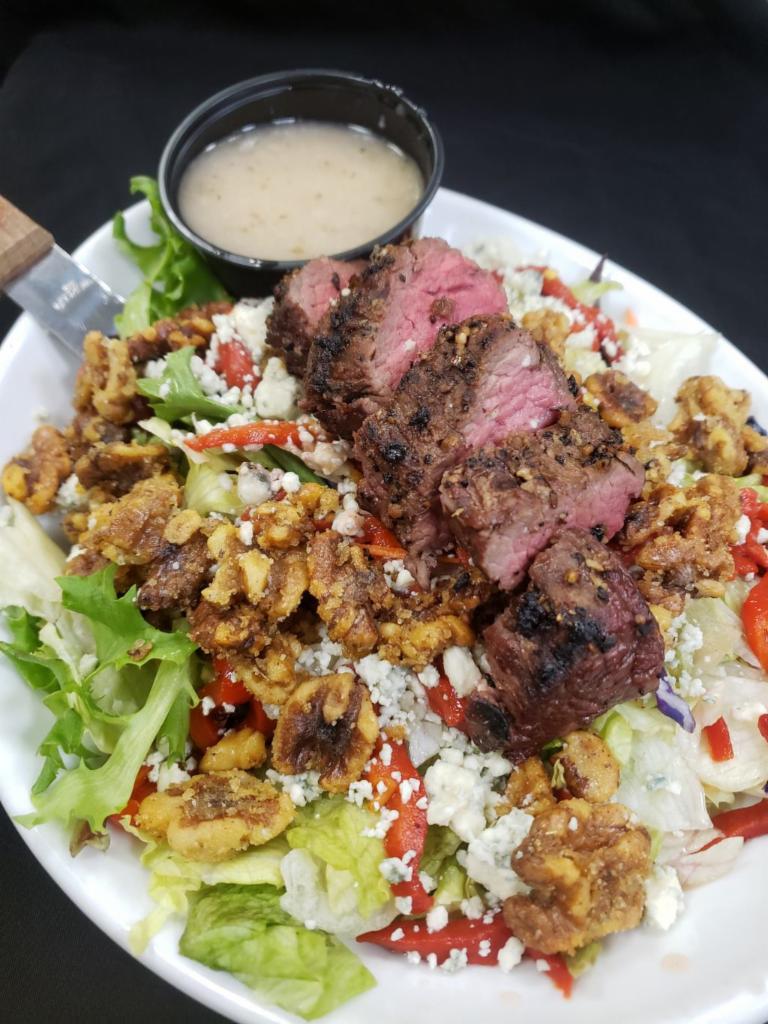 Hooligans Steakhouse Salad  · Mixed greens, sirloin medallion, roasted red peppers,
candied walnuts, bleu cheese crumbles, sweet shallot
vinaigrette. Gluten-free.