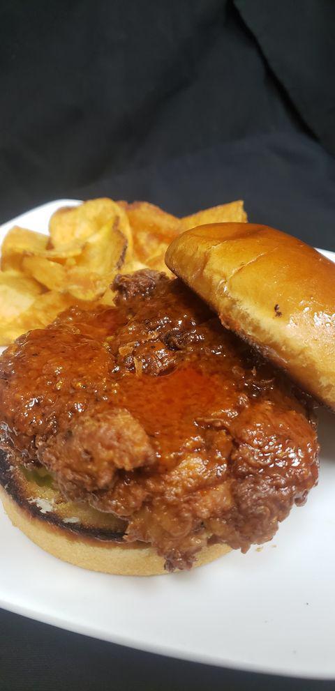 Nashville Chicken Sandwich  · House breaded spicy fried chicken, dipped in Nashville
hot sauce, on a toasted brioche bun with dill pickle chips and habanero cheese spread. 
