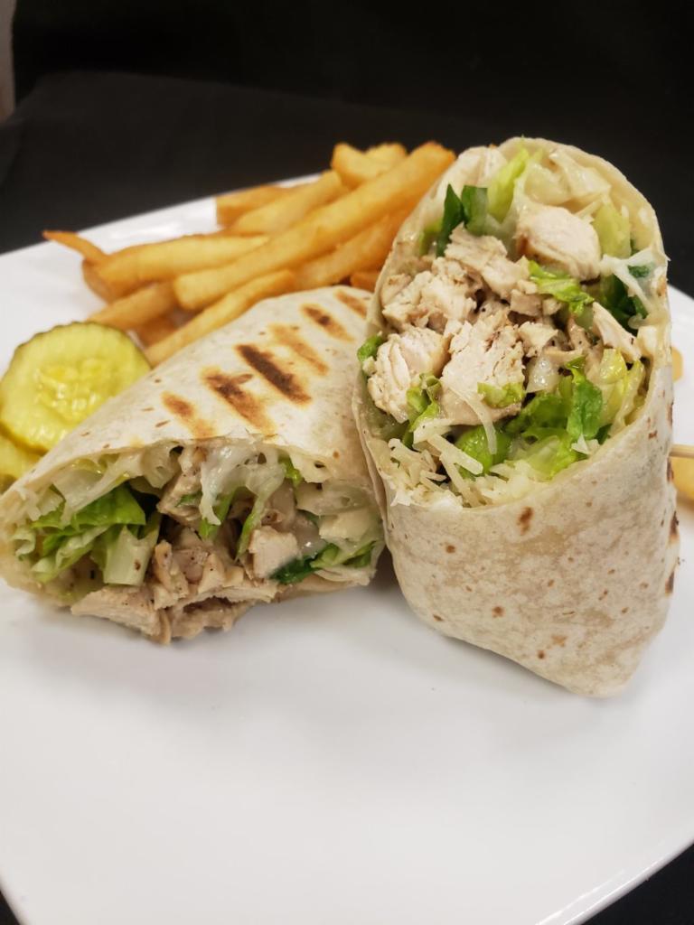 Chicken Caesar Wrap  · Grilled chicken breast, chopped romaine, shaved Parmesan, and creamy Caesar dressing in a pressed flour tortilla.