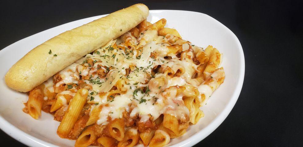 Baked Ziti  · Ziti tossed with Italian sausage and house made marinara, then topped with melted mozzarella and shaved Parmesan. Served with a side salad and a breadstick.