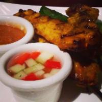 4 Satey  · Grilled marinated chicken, pork, or beef skewers served with peanut sauce and cucumber salad...