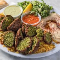 Vegan Combination Dinner · (gluten free option available)
3 falafels cut up on top of your choice of rice. Sides of Hum...