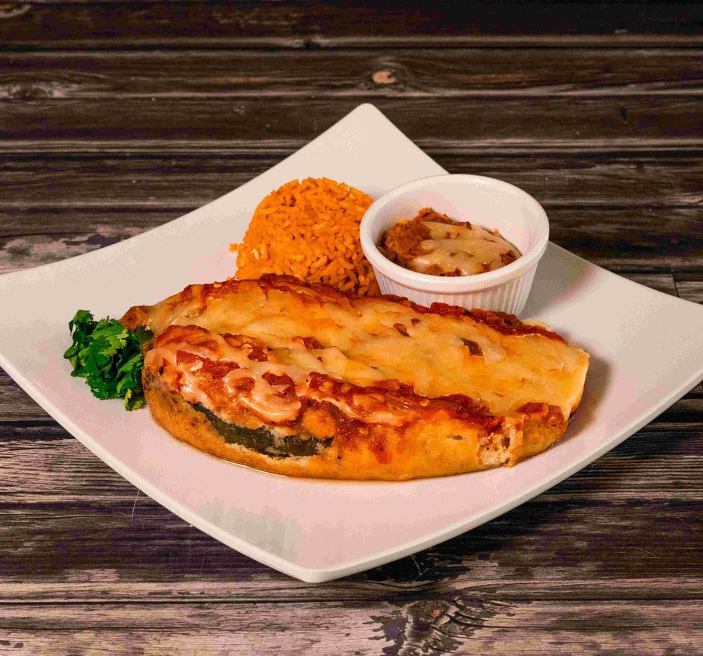 Chiles Rellenos Plate · Grilled California green chiles stuffed with cheese and salsa ranchera. Served with rice, refried beans and warm homemade tortillas.