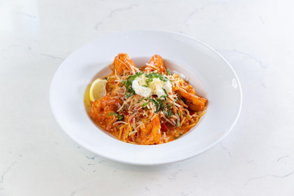 Spicy Shrimp Pasta · Organic whole-wheat spaghetti pasta with spicy shrimp, basil chiffonade, garlic, tomatoes, shallots, red and yellow bell peppers, jalapeño, ricotta and Parmesan cheese with organic tomato cream sauce with the lobster base.