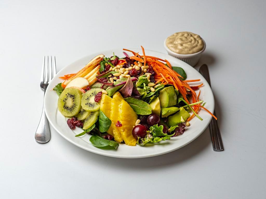 House Salad (GFO) · Ginger sauce served with spring mix, romaine lettuce, grapes, kiwi, carrots, apple, pine nuts, grape tomato, cucumbers, avocado and cranberries. Gluten-free.