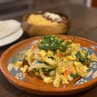 Huevos A La Mexicana · Scramble eggs with jalapeno pepper, tomatoes, onions, rice, beans and tortilla.