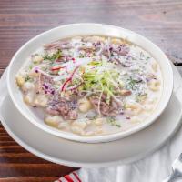 Pozole · Corn soup with hominy, pork, chili served with one tostada.