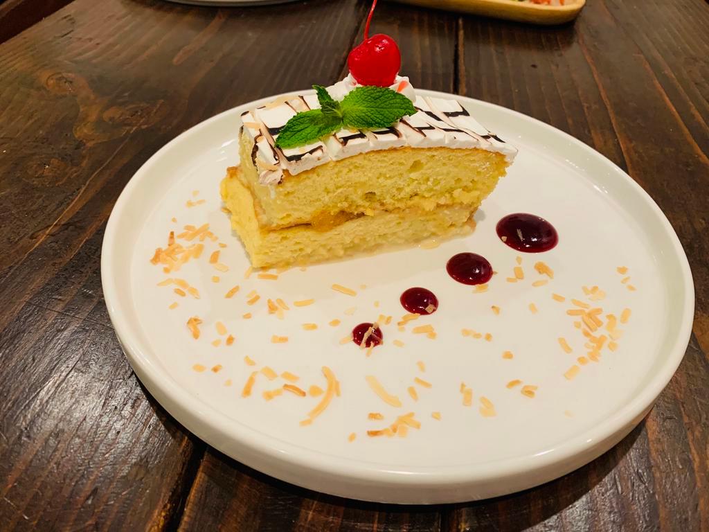 Pastel Tres Leche · Homemade three-milk cake served with strawberry at ease in syrup.