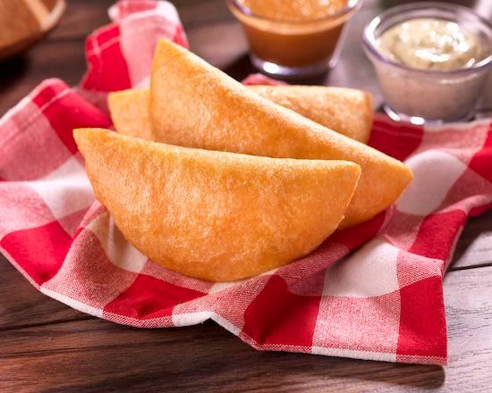 Empanada (Fried) Pabellon · Fried Venezuelan style cornmeal empanada filled with shredded beef, shredded chicken or Cazon, white cheese, black beans, and yellow plantain.