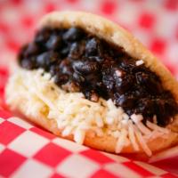 Arepa Domino · Arepa filled with White cheese and black beans.
