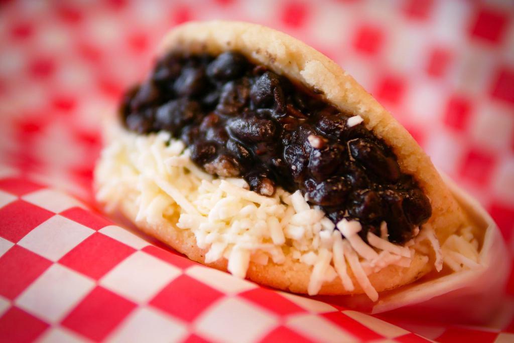 Arepa Domino · Arepa filled with White cheese and black beans.