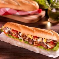 Pepito Chicken · Lettuce, onions, tomatoes, potato sticks, mustard, ketchup, and engy sauce on a baguette bre...