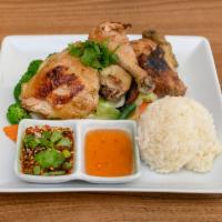 Gai Yang · Grilled marinated half chicken with spicy and sweet chili. Served with steamed vegetables an...