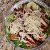 Crispy Chicken Salad · Breaded chicken served over mixed greens, roasted red peppers, sliced cucumbers, and shredde...