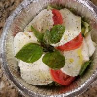 Caprese Salad · Fresh Roma tomatoes, sliced fresh mozzarella, fresh basil, salt pepper, virgin olives on and...