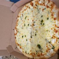 Pesto Pizza · White pie drizzled with our home-made pesto sauce.