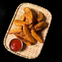 Potato Wedges Fries · Thick wedges Fries with garlic butter serve with original sauce.