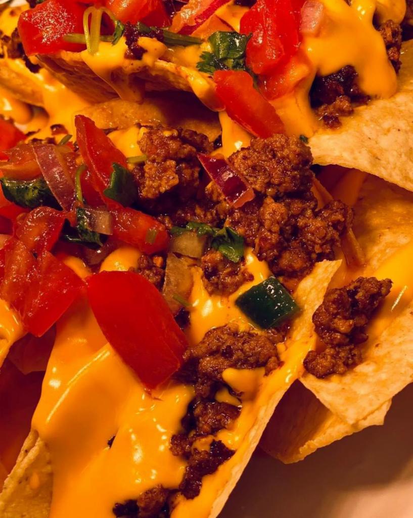 Nachos · Fresh made chips with jalepeno queso topped with pico