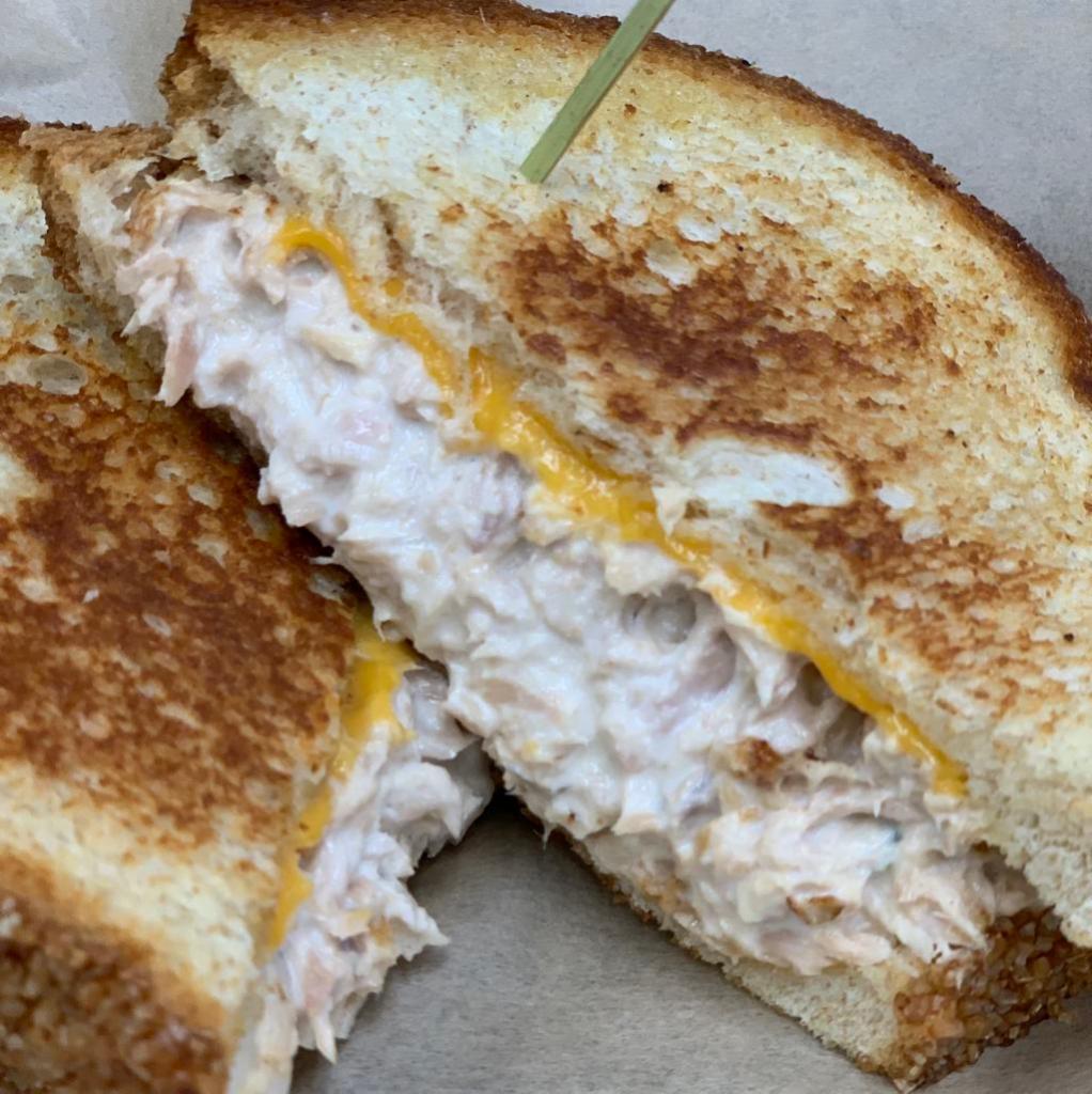 Tuna Melt · Freshly made tuna salad grilled with Cheddar cheese on your choice of fresh bread. Served with fries or slaw.