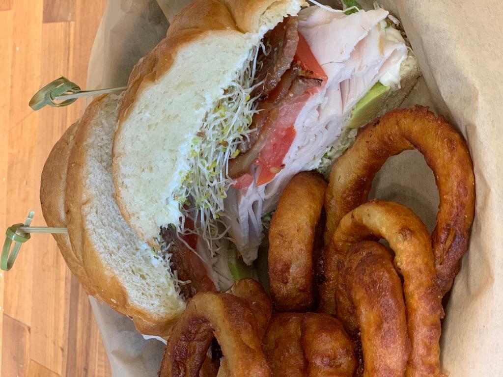 Kathys Kroissant · Cracked Pepper turkey, Applewood bacon, sprouts, avocado, tomato, mayo on a croissant. Served with fries or slaw.