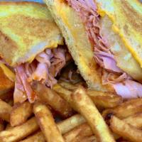 Saras Twisted Sister · Sweet and spicy glazed pit ham, Cheddar cheese, pineapple, and tomato. Served on grilled art...