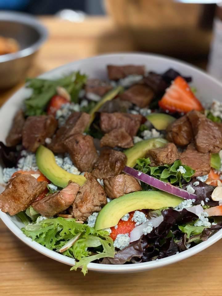 Black and Bleu Salad · Mixed greens with grilled steak, strawberries, Bleu cheese crumbles, almonds, red onion, and avocado with balsamic vinaigrette.