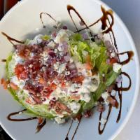 The Wedge · Iceberg wedge, red onion, tomato, bacon, Bleu cheese dressing, balsamic glaze and  topped wi...