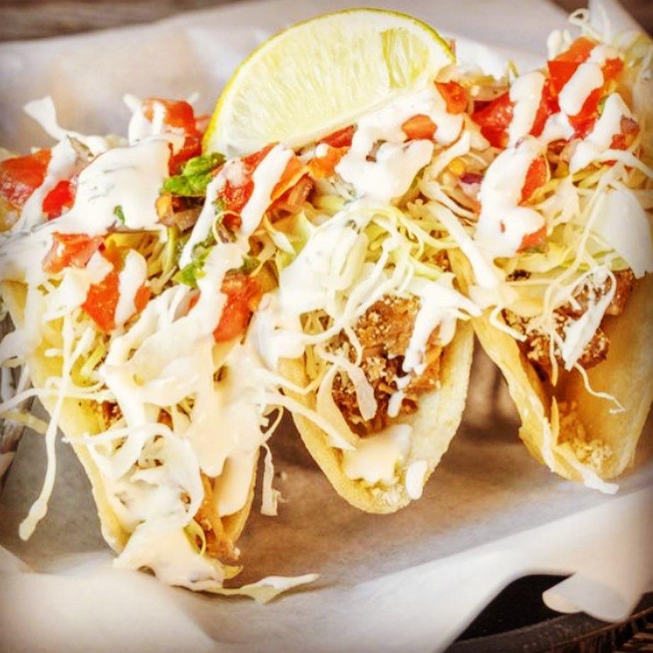 Fish Tacos · Hand-dipped beer-battered fish with shredded cabbage, cilantro lime sauce, and a side of pico de gallo. Your choice of flour or corn locally made tortillas.