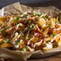 Bacon Cheese Fries · Cheddar Jack cheese, a layer of chopped bacon, Ranch and fresh scallions.