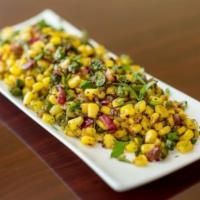 Spicy Corn · Sauteed corn with fresh tomatoes, onion and peanut spicy dressing.