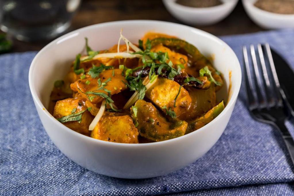 Kadai Paneer · Paneer cooked with tomatoes, onions, bell peppers and a blend of Indian spices.