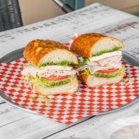 The Goodfella Sandwich · Roasted turkey, pesto and fresh mozzarella served with lettuce and tomatoes. Not served hot.