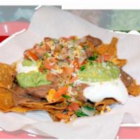 Nachos With Guacamole  · Beans, cheese, sour cream, guacamole and Mexican salsa.