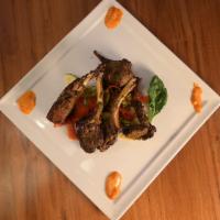 Adraki Lamb Chops · Rack of lamb marinated in house ground spices, cooked in cylindrical clay oven. Served with ...