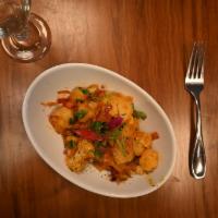 Aaloo Gobi-D · Potatoes and cauliflower sauteed with house ground spices. Served with a side of our vegan b...